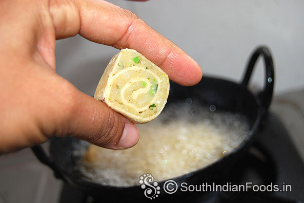 Heat enough oil in a pan, drop raw bakarwadi